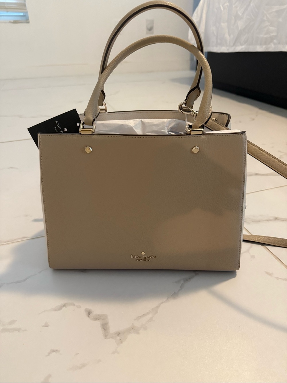 kate spade beige leather satchel with top handles and crossbody strap